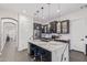 Bright kitchen with stainless steel appliances, quartz counters, and eat-in island at 20689 W Valley View Dr, Buckeye, AZ 85396