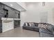 Comfortable living room with a stone fireplace, built-in shelves, and plush gray sofa at 20689 W Valley View Dr, Buckeye, AZ 85396