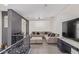 Cozy living area featuring a plush sectional sofa, neutral decor, and a contemporary entertainment center at 20689 W Valley View Dr, Buckeye, AZ 85396