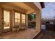 Covered patio features tiled flooring, a lounge area, and an outdoor kitchen perfect for entertaining at 20689 W Valley View Dr, Buckeye, AZ 85396