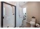 Bright bathroom with walk-in shower and toilet, with views to stairs and hall at 21194 W Hillcrest Blvd, Buckeye, AZ 85396