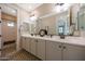 Bathroom features a large vanity with double sinks, and a wall to wall mirror at 21194 W Hillcrest Blvd, Buckeye, AZ 85396