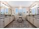Modern bathroom featuring double vanities, decorative area rug, stool, and designer touches at 21194 W Hillcrest Blvd, Buckeye, AZ 85396