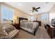 Main bedroom with carpet, ceiling fan, shutters, chair, and private view at 21194 W Hillcrest Blvd, Buckeye, AZ 85396