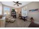 Comfortable bedroom with carpet, ceiling fan, shutters, chair, and office nook at 21194 W Hillcrest Blvd, Buckeye, AZ 85396