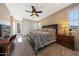 Main bedroom with carpet, ceiling fan, dresser, and access to private balcony at 21194 W Hillcrest Blvd, Buckeye, AZ 85396