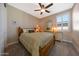 Cozy bedroom features carpet, ceiling fan, shutters, lamps, and stylish decor at 21194 W Hillcrest Blvd, Buckeye, AZ 85396