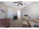 Open bedroom with carpet, ceiling fan, chair, and large dresser at 21194 W Hillcrest Blvd, Buckeye, AZ 85396
