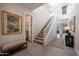 Bright and open entryway with hardwood floors, staircase, and stylish decor, creating a welcoming ambiance at 21194 W Hillcrest Blvd, Buckeye, AZ 85396