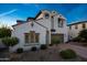 Inviting two-story home displaying neat desert landscaping and a brick paved driveway at 21194 W Hillcrest Blvd, Buckeye, AZ 85396