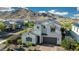 Beautiful two-story home with neutral stucco, dark accents, a paver driveway and mature landscaping at 21194 W Hillcrest Blvd, Buckeye, AZ 85396