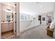 Hallway view into an open concept floor plan, with view to a bathroom and living space at 21194 W Hillcrest Blvd, Buckeye, AZ 85396
