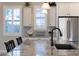 Close-up of a kitchen island with granite countertops, stainless steel appliances, and window shutters at 21194 W Hillcrest Blvd, Buckeye, AZ 85396