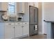 Kitchen detail showing stainless steel refrigerator, custom cabinetry and granite counters at 21194 W Hillcrest Blvd, Buckeye, AZ 85396