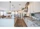 Well-appointed kitchen with a central island, stainless appliances, and views of the living area at 21194 W Hillcrest Blvd, Buckeye, AZ 85396