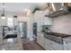 Close-up of the kitchen's cooking area with stainless appliances, and custom cabinets at 21194 W Hillcrest Blvd, Buckeye, AZ 85396