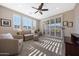 Comfortable living room featuring ceiling fan, plush carpeting, comfortable seating, and window views at 21194 W Hillcrest Blvd, Buckeye, AZ 85396