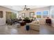 Bright living room with neutral tones, tile floors, and sliding glass doors to the backyard at 21194 W Hillcrest Blvd, Buckeye, AZ 85396