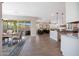 Open living space seamlessly connecting the kitchen, dining area, and living room with beautiful flooring at 21194 W Hillcrest Blvd, Buckeye, AZ 85396