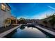 Inviting backyard pool and spa, perfect for relaxing and entertaining under the evening sky at 21194 W Hillcrest Blvd, Buckeye, AZ 85396