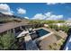 Aerial view of a backyard featuring a pool, spa, and landscaped area for outdoor enjoyment and relaxation at 21194 W Hillcrest Blvd, Buckeye, AZ 85396