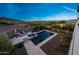 Beautiful backyard pool with travertine pavers, sun-loungers, and scenic views at 21194 W Hillcrest Blvd, Buckeye, AZ 85396