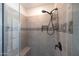 Modern shower featuring gray tile, a built-in niche, and a handheld shower head at 21194 W Hillcrest Blvd, Buckeye, AZ 85396