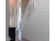 Bright stairway with white wood trim, a shiplap accent wall, and views to an adjacent room at 21194 W Hillcrest Blvd, Buckeye, AZ 85396