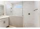 Modern bathroom showcasing a glass-enclosed shower with stylish tiling, complemented by a sleek vanity and fixtures at 21228 N 58Th St, Phoenix, AZ 85054