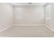 Well-lit bedroom featuring neutral colors, carpet, and multiple windows, creating a welcoming and bright space at 21228 N 58Th St, Phoenix, AZ 85054