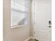 Bright entryway featuring a white front door with modern hardware and natural light streaming through the window at 21228 N 58Th St, Phoenix, AZ 85054