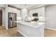 Stylish kitchen boasting a large island, stainless steel appliances, and modern lighting for an inviting cooking space at 21228 N 58Th St, Phoenix, AZ 85054