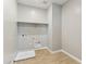 Well-lit laundry room with wood-look flooring, and hookups for laundry equipment at 21228 N 58Th St, Phoenix, AZ 85054