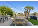 Waterfront backyard featuring a wooden picnic table and an outdoor bar, with chairs, perfect for entertaining guests at 2135 E Clipper Ln, Gilbert, AZ 85234