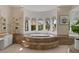 Luxurious bathroom features a large soaking tub and bright window at 2135 E Clipper Ln, Gilbert, AZ 85234