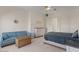 Comfortable bedroom with a blue sofa, dresser, and plush carpeting at 2135 E Clipper Ln, Gilbert, AZ 85234