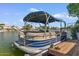 Boat docked on the lake surrounded by lakeside homes at 2135 E Clipper Ln, Gilbert, AZ 85234