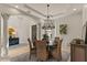 Open dining room featuring stylish lighting and seating for six at 2135 E Clipper Ln, Gilbert, AZ 85234