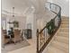 Open-concept foyer featuring elegant curved staircase and dining area with ample lighting at 2135 E Clipper Ln, Gilbert, AZ 85234