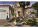 Charming front exterior of a home with mature landscaping, a circular driveway, and a welcoming entrance at 2135 E Clipper Ln, Gilbert, AZ 85234