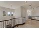 Bright hallway with decorative railing and pendant lighting at 2135 E Clipper Ln, Gilbert, AZ 85234