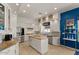 Bright kitchen featuring white cabinetry, an island, granite countertops, and stainless steel appliances at 2135 E Clipper Ln, Gilbert, AZ 85234