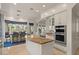 Open kitchen featuring granite island, stainless oven and seating with large windows at 2135 E Clipper Ln, Gilbert, AZ 85234
