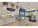 Bright kitchen featuring white cabinetry, an island, granite countertops, and stainless steel appliances at 2135 E Clipper Ln, Gilbert, AZ 85234