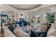 Bright, open living room with views of the lake, fireplace, and stylish furniture at 2135 E Clipper Ln, Gilbert, AZ 85234