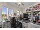 Functional home office with built-in shelving, desk, and large windows overlooking the lake at 2135 E Clipper Ln, Gilbert, AZ 85234