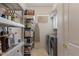 Walk-in pantry with shelving, laundry appliances, and ample storage space at 2135 E Clipper Ln, Gilbert, AZ 85234