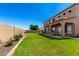 Spacious backyard showcasing the home's architecture, lush lawn, and an array of outdoor amenities at 21605 S 187Th Way, Queen Creek, AZ 85142