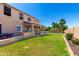 Expansive backyard showcasing a well-manicured lawn, covered patio, outdoor kitchen, and a sparkling swimming pool at 21605 S 187Th Way, Queen Creek, AZ 85142