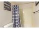 Bright bathroom with a neutral-colored shower, decorative shower curtain and Gathering quote art at 21605 S 187Th Way, Queen Creek, AZ 85142